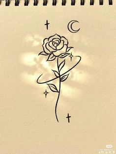 a drawing of a rose with the moon and stars on it's back side