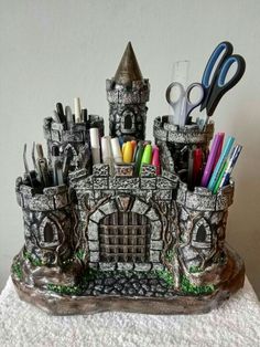 there is a small castle with scissors and pens in it