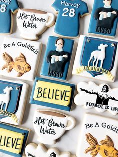 decorated cookies are arranged in the shape of t - shirts and mugs with names on them