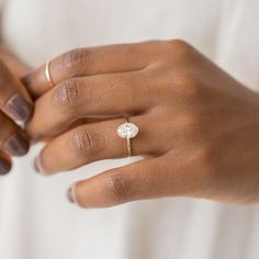 a close up of a person wearing a ring with a flower on it's middle finger