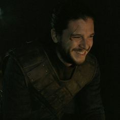 a man in armor smiling at the camera