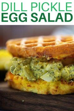 a close up of a waffle sandwich on a wooden board with the words dill pickle egg salad