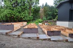 several wooden boxes sitting in the middle of a yard