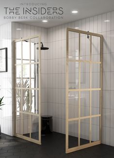 the inside of a bathroom with two glass doors