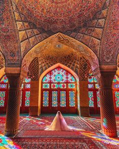 the inside of an ornate building with colorful stained glass windows and arches on each side