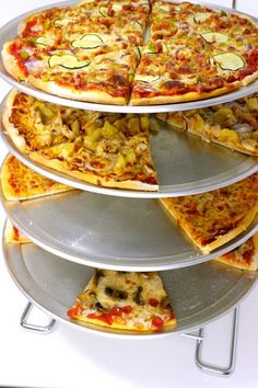 there is a pizza that has been cut into eight slices and stacked on three tiers