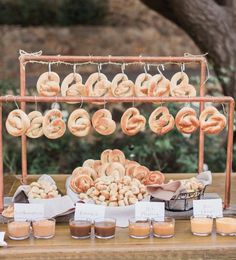 a table topped with lots of doughnuts and other food on top of it