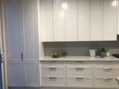 a kitchen with white cabinets and gold trim on the doors, counter tops and drawers