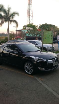 a black car parked in front of a parking meter