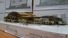 a model of a building on display in a glass case