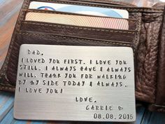 a wallet with a card holder on top of it and a metal tag that says, i loved you first i love you still