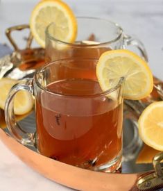 two glasses of tea with lemon slices on the rim