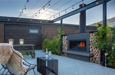 a patio with a fire place and chairs