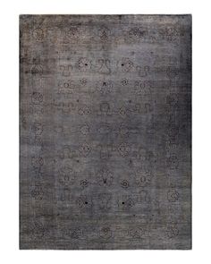 an antique rug with many different designs on the top and bottom, in grey tones