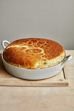 a baked dish sitting on top of a wooden cutting board