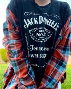 🍂🥃 Orangey Whiskey Drink Flannel🍂🥃   ~ Orange and Turquoise Flannel with a Black Jack Daniels Shirt  🥀Fits best: Unisex XL🥀 ✨Models: Female- is a Medium and is 5'2.  Male- is a L-XL and is 5'10 Whisky Drink, Jack Daniels Shirt, Whiskey Drinks, Black Jack, Orange And Turquoise, Jack Daniels, Jack Black, Whiskey, Adult Outfits