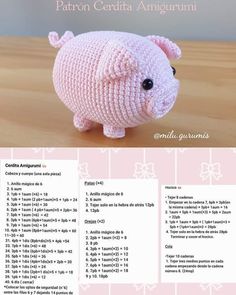 a pink crocheted pig sitting on top of a wooden table next to a white wall