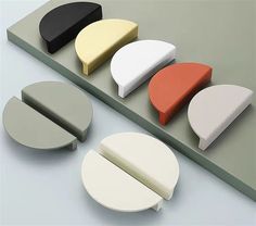 several different shapes and sizes of furniture on a table with white, black, yellow, red, and green accents