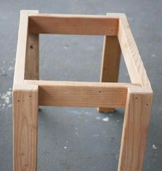 a wooden chair sitting on top of a cement floor