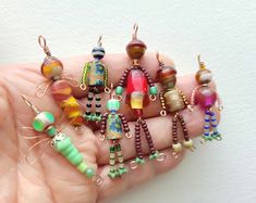 there are many different colored beads in the hand