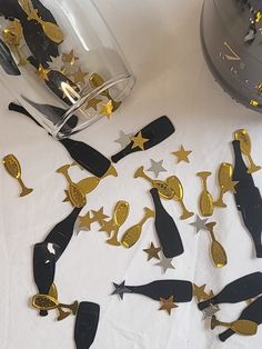 some gold and black decorations on a white table