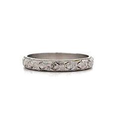 Vintage Art Deco Engraved Orange Blossom Band in Platinum This Art Deco wedding band showcases the elegance and meticulous craftsmanship of the early 20th century. Crafted from polished platinum, the band features an intricate Orange Blossom engraved pattern that wraps around the entire circumference. The detailed engraving highlights the exceptional artistry of the era. Milgrain edges add a refined touch, enhancing the overall design. Perfect as a wedding band or a standalone piece, this ring combines historical charm with timeless beauty, making it a cherished addition to any jewelry collection. CHARACTERISTICS Ring Size: 6.0 Resizable: Yes Height Above Finger: 1.35 mm Measurements: 3.10 mm Era: Art Deco/Antique Composition: Platinum Total Gram Weight: 3.2 g Inscription: PLATINUM -- ALL Blossoms Band, Art Deco Wedding Band, Platinum Rose Gold, Sapphire Solitaire, Deco Wedding, Art Deco Wedding, Shop Engagement Rings, Orange Blossom, Vintage Art Deco