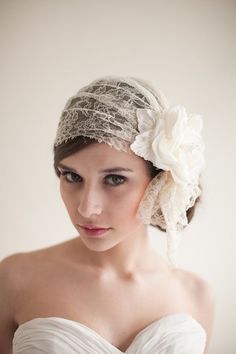 a woman wearing a white dress and a flower in her hair