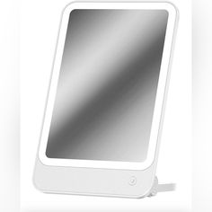 an electronic device with a mirror attached to the front and side of it, on a white background