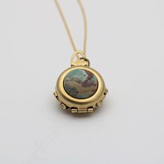 "*Our current stock of green opal is a dark mossy green* A spring-loaded locket pops open to reveal 2 hinged panels, just 1\" in diameter.  It opens to hold 4 photographs. The feature of this unique locket is a green opal.  This is considered a cleansing and rejuvenating stone. These are natural stones and each one will be different.  ~Comes on a 24\" chain" Family Heirloom Jewelry, Unique Locket Necklace, Unique Jewelry Vintage, Unique Locket, Necklace Family, Locket Design, Mossy Green, Heirlooms Jewelry, Family Jewels