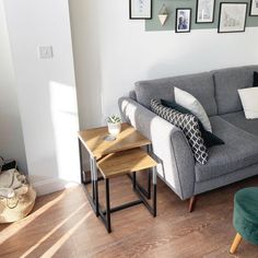 a living room filled with furniture and pictures on the wall