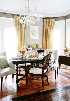 a dining room table with chairs and a chandelier