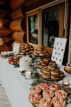 many donuts are lined up on a table