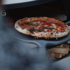 a pizza is being cooked in an oven