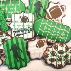 decorated cookies with green and white stripes are arranged in the shape of an american football field