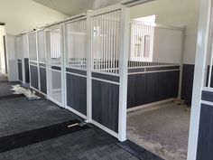 the inside of a horse barn with stalls and stalls on either side of the room