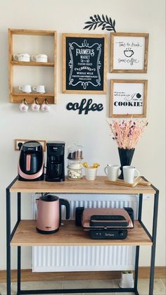 the coffee bar is set up in front of some framed pictures and other things on the wall