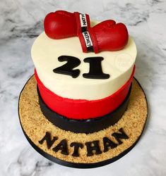 a birthday cake decorated to look like a boxing glove and the number twenty one on it