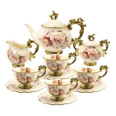 a set of five tea cups and saucers with matching saucers in the shape of roses