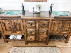 a bathroom with two sinks and a wooden cabinet in the middle on a white rug