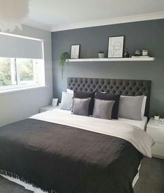 a large bed sitting under a window in a bedroom