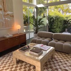 a living room filled with furniture and a large glass door leading to an outside patio