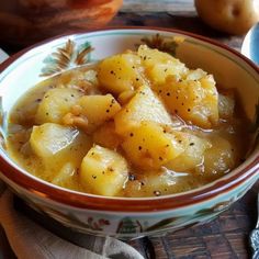 a bowl filled with potatoes sitting on top of a table