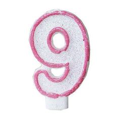 the number nine is pink and white with glitter on it's sides, as well as letters