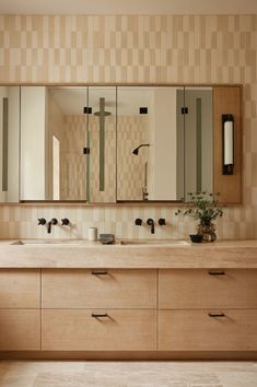 a bathroom with two sinks and mirrors in it