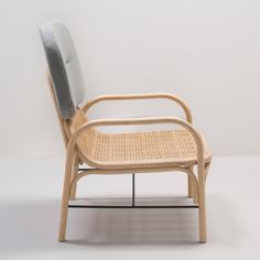 the chair is made out of wood and has a gray cushion on it's back