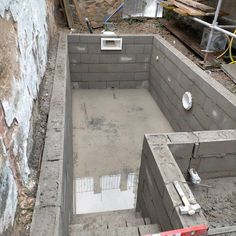 an unfinished pool being built in the middle of a construction site with concrete walls and flooring