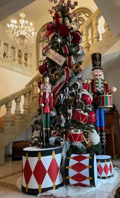 a christmas tree decorated with nutcrackers and other holiday decorations in front of a staircase