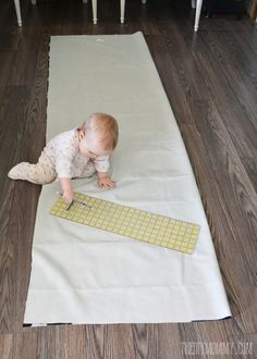 a baby crawling on a mat with a keyboard in front of it that is laying on the floor