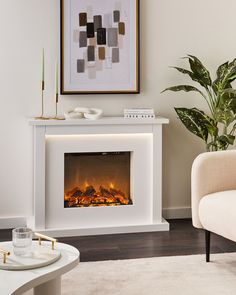 a living room with a couch and a fire place in the center, next to a chair