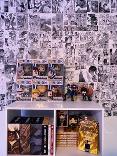 a book shelf filled with comic books next to a wall covered in comics and pictures